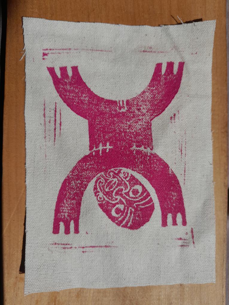 Kahurangi Douglas’ block print of ‘tāne te irawhiti’. A pink print of tāne te irawhiti with head to the ground and legs pushing to the sky with top surgery scars.